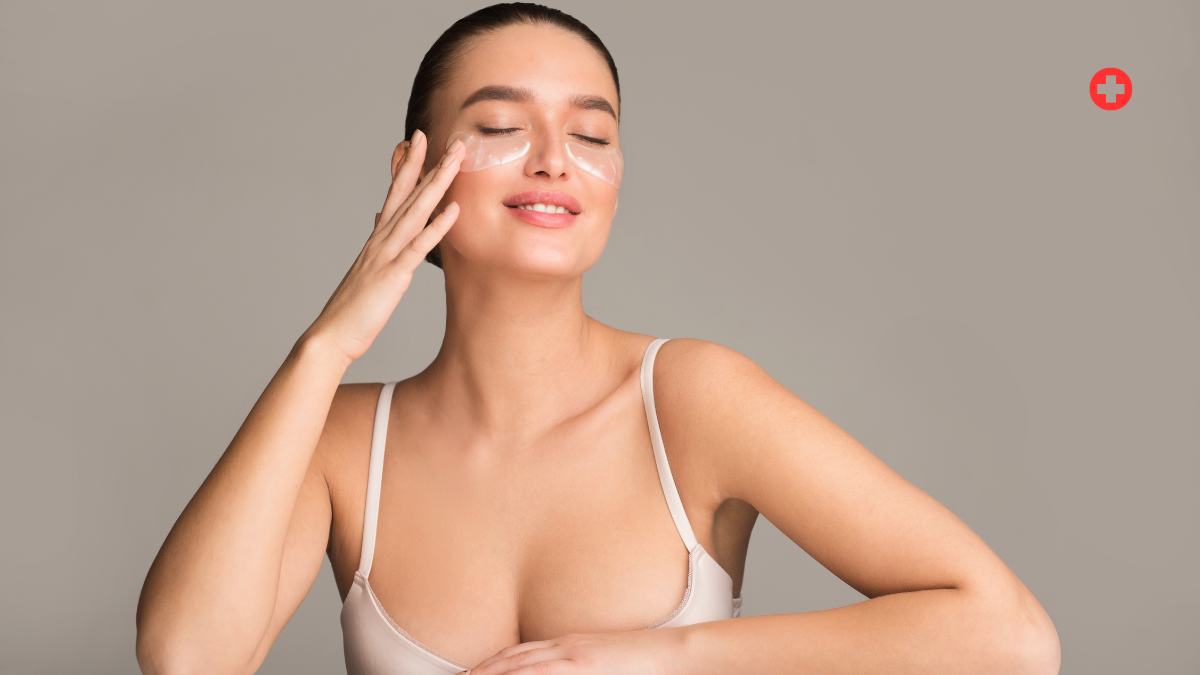 Woman applying skincare product on face
